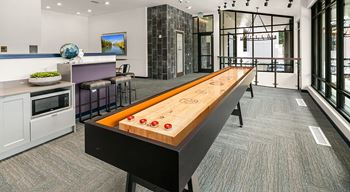 a games room with a shuffleboard table
